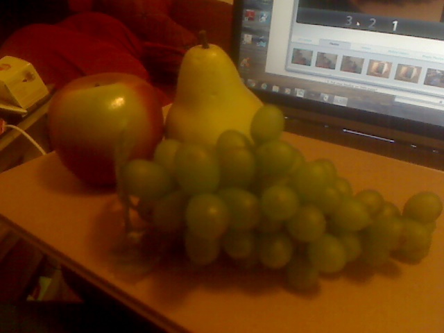 Still life arrangement with three artificial fruits.